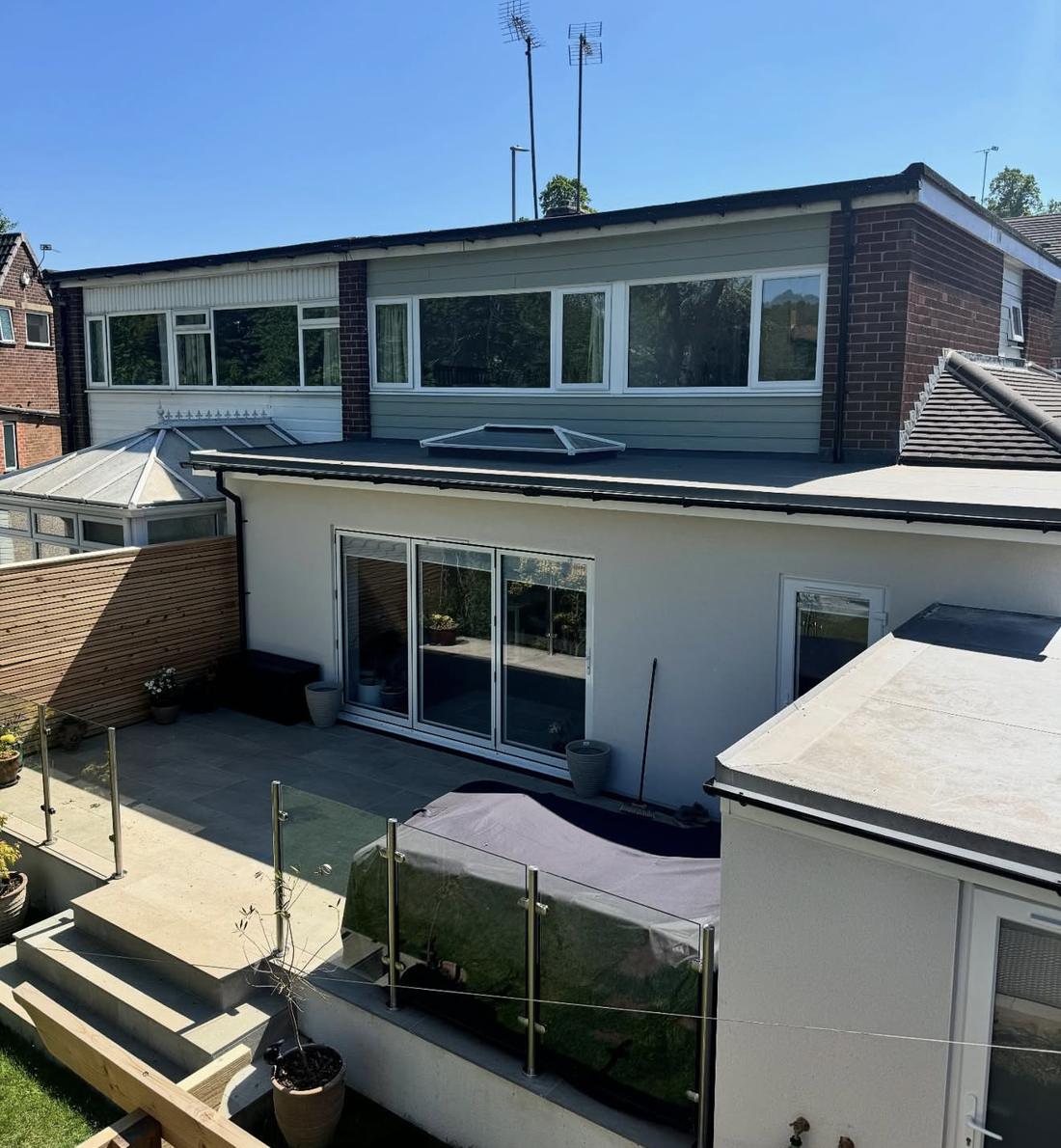 After: finished wrap-around extension with flat roof, roof lantern and rendered walls