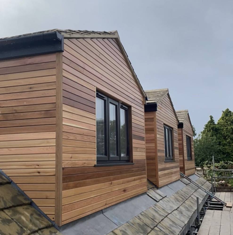 Row of dormers clad in red cedar
