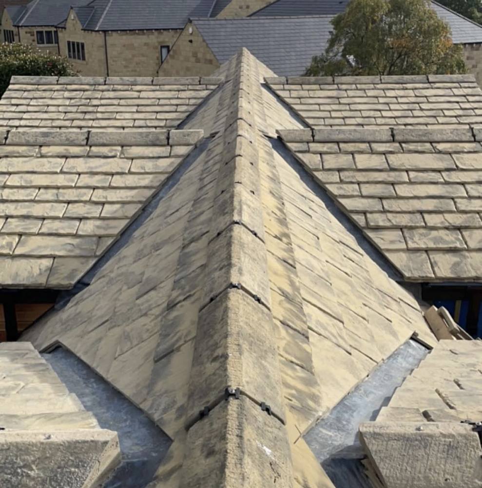 Stone slate roof ridge meeting the main roof
