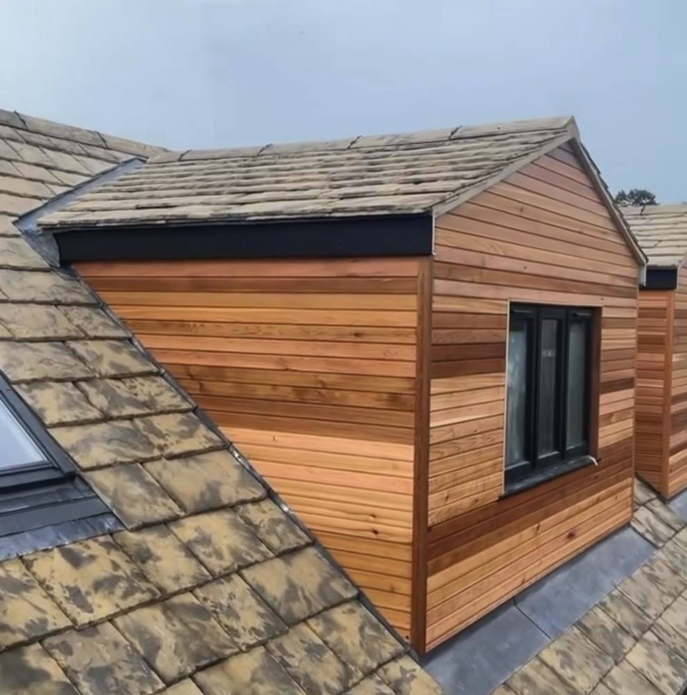 Cedar-clad dormer on a stone slate roof