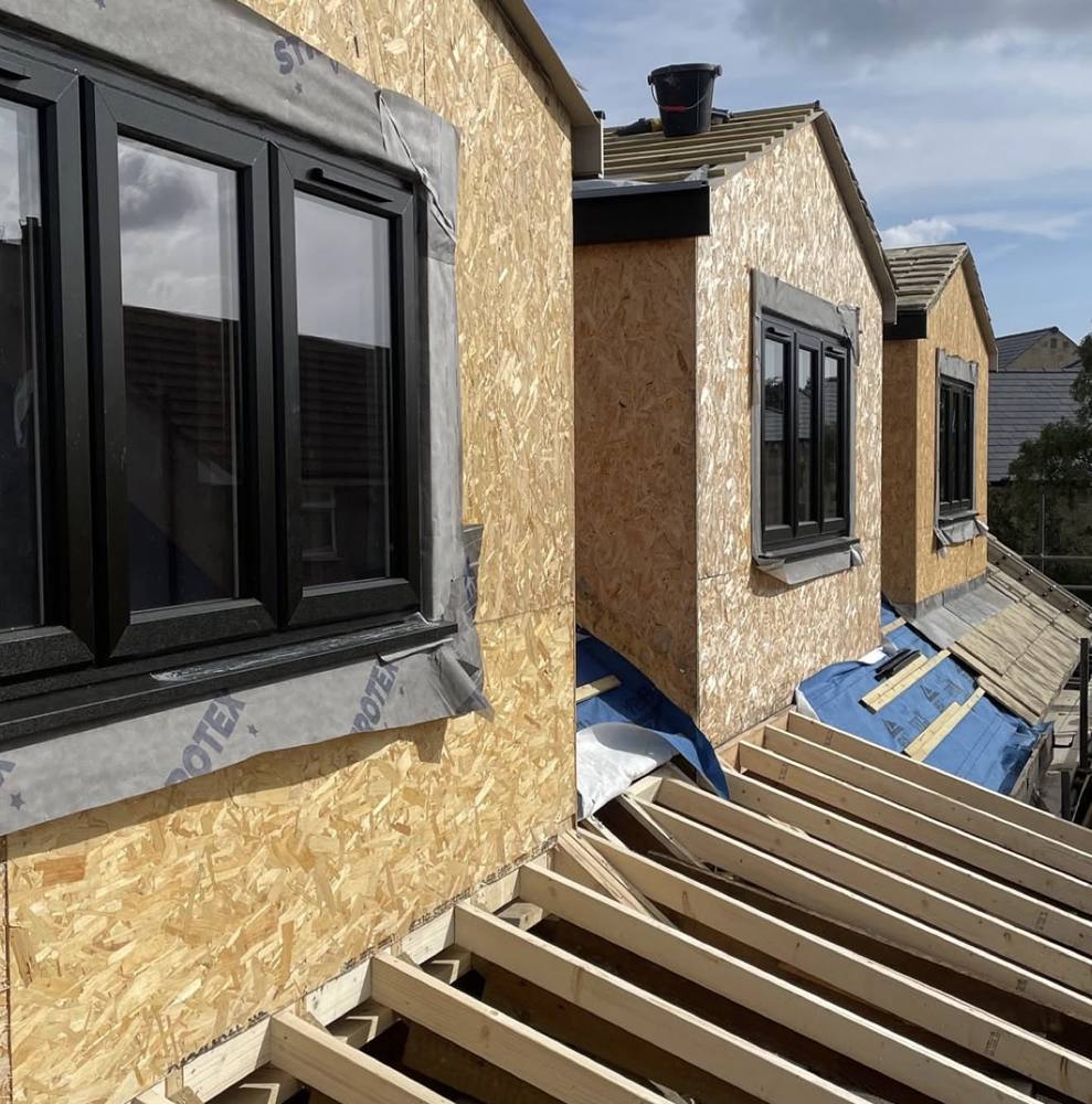 Dormers sheathed in OSB with windows fitted, before cladding