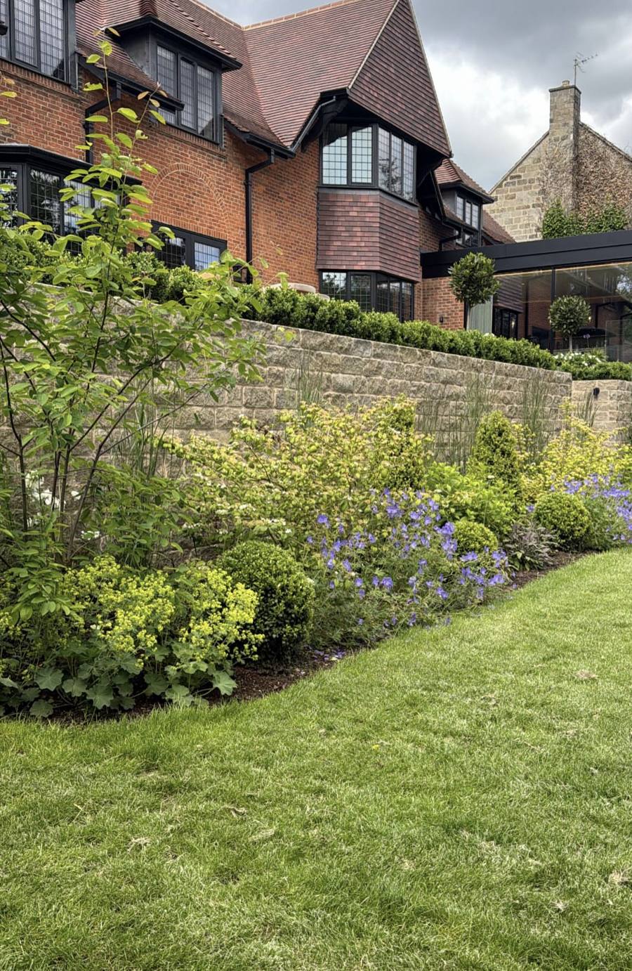 Retaining wall behind planted borders