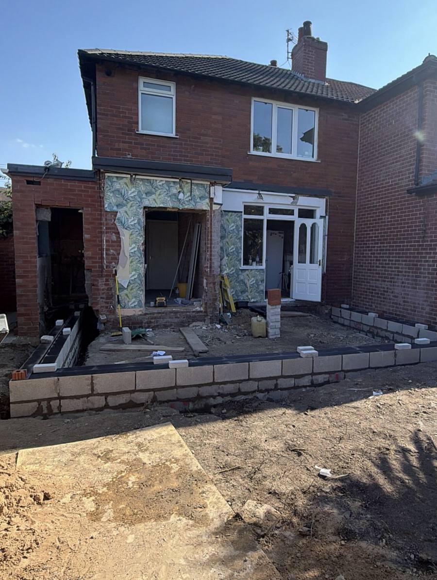 Blockwork footings laid out behind a semi-detached house