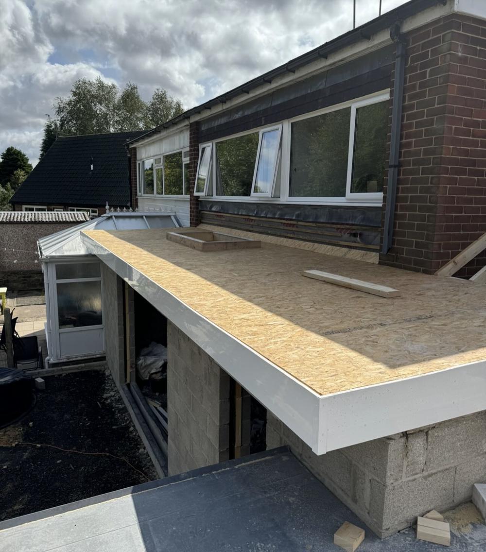 Flat roof decked in timber boards before the membrane went on